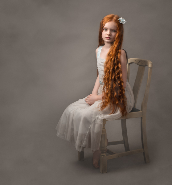 young girl with red hair sitting for fine art photography session