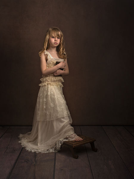 Girl with curly blond hair standing for a fine art photo session