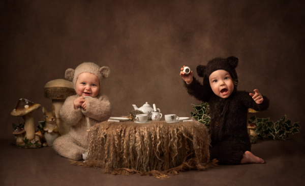 two babies dressed as bears having a picnic for a fine art photography session