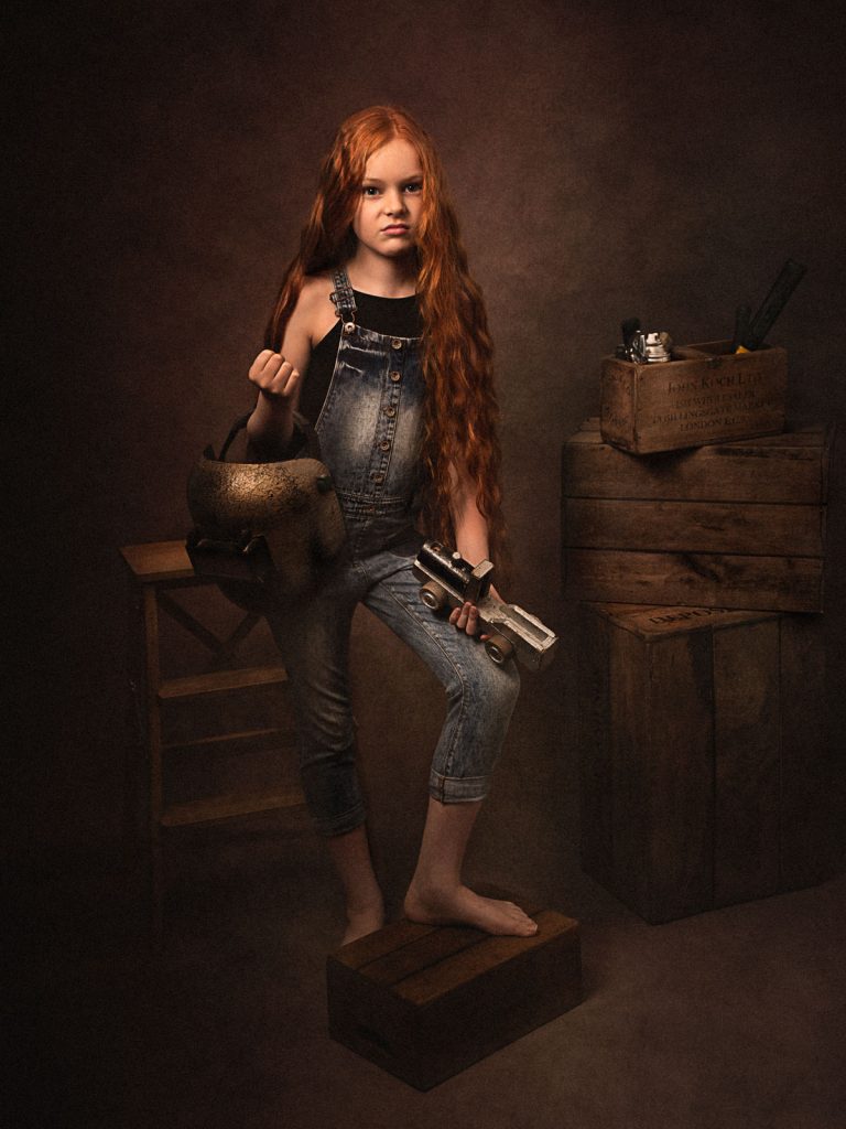old style blacksmith child in dungarees