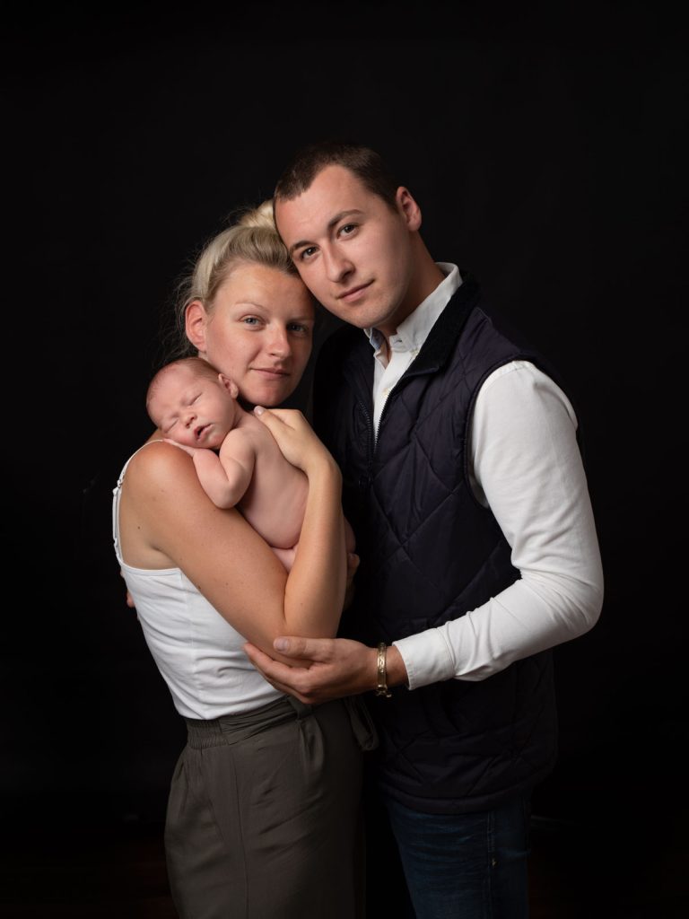 newborn baby with parents family portrait photo