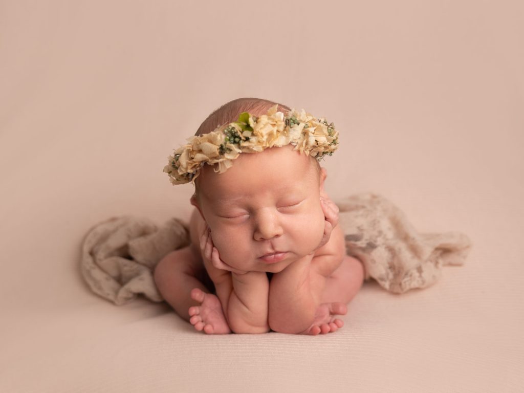 newborn baby with flowers