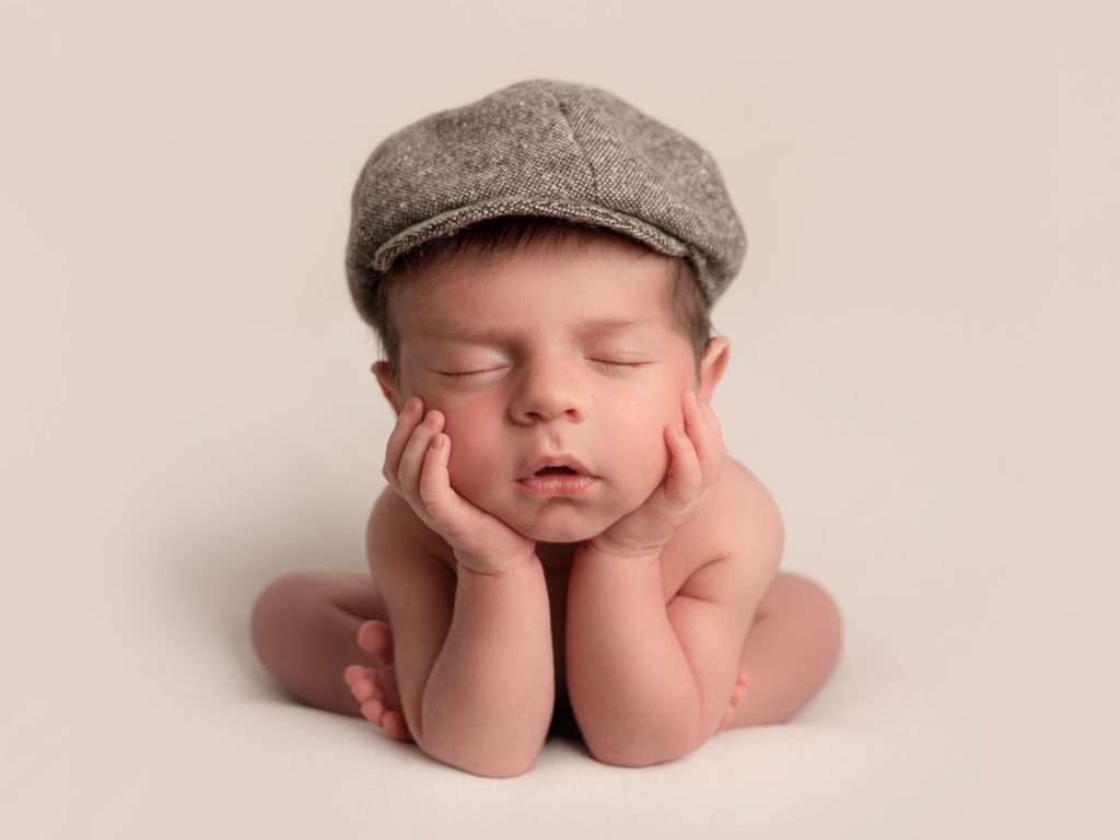 newborn baby with flat cap on