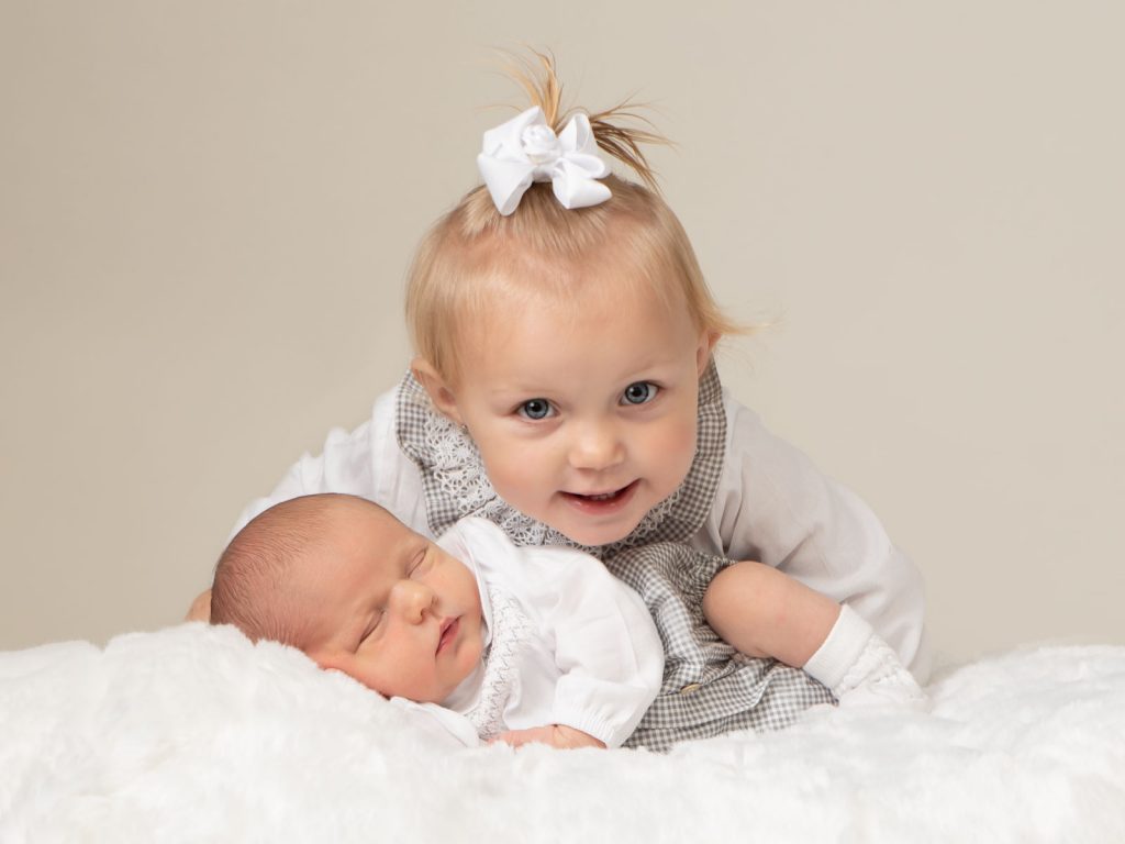 newborn baby with older sibling