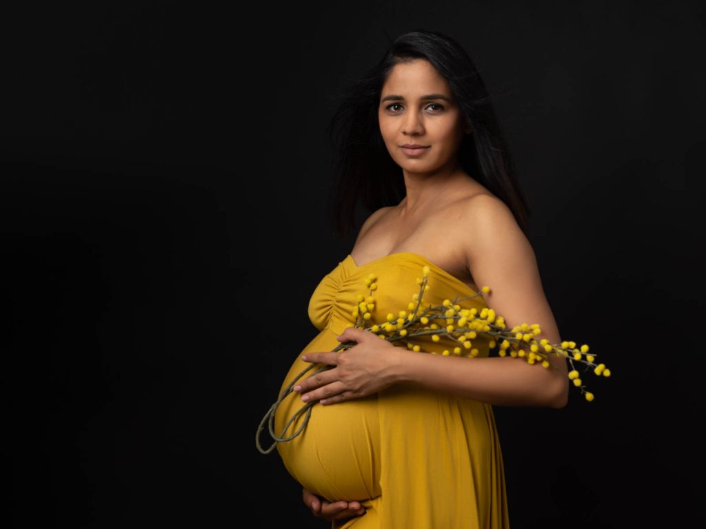 dark background with bold dress maternity photoshoot