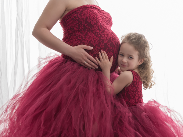 stunning red dress on pregnant mother and her daughter
