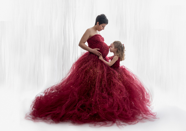 stunning red dress on pregnant mother and her daughter
