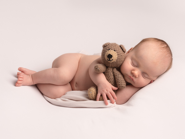 baby asleep with teddy bear newborn photoshoot