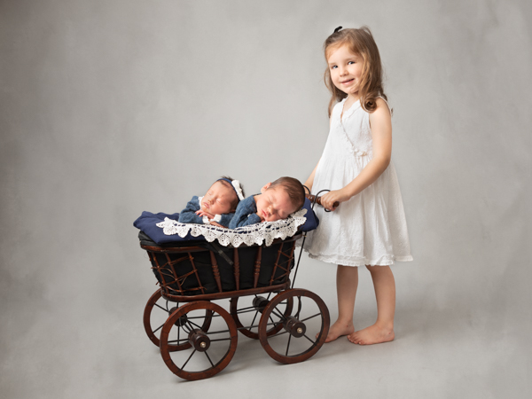sister pushing twins in old style pram