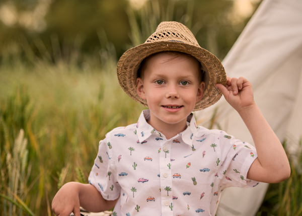 boy in a hat in a field outdoor photography