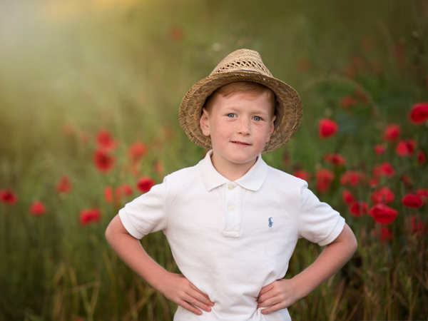 boy in a hat in a field outdoor photography