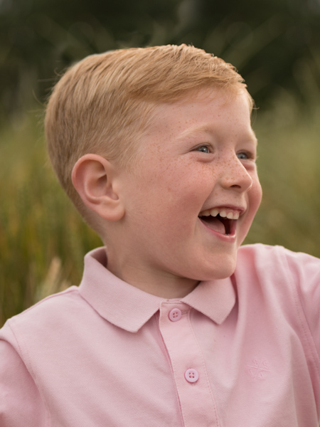 happy boy in a pink shirt