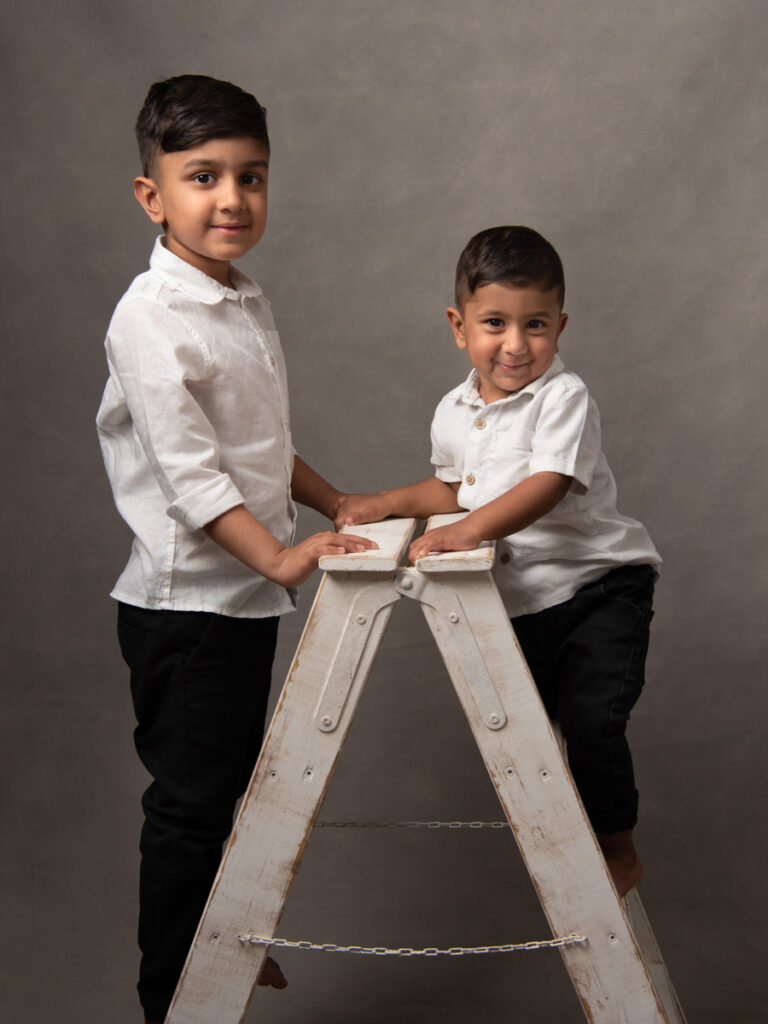 Two brothers on a ladder studio portrait Essex
