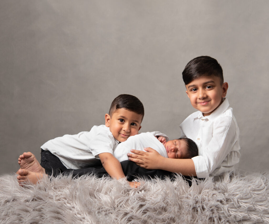 Two brothers and newborn baby photoshoot Essex