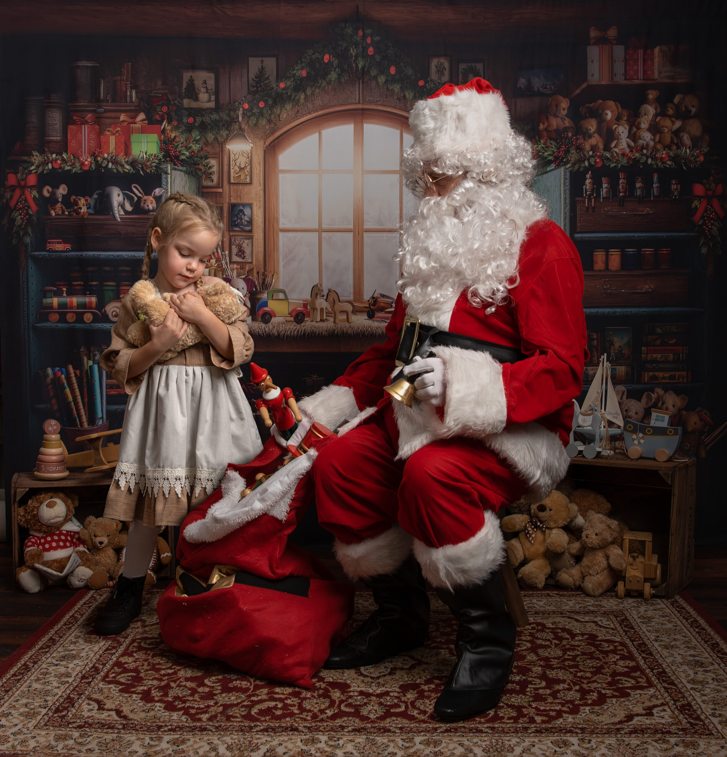 girl in vintage dress cuddling teddy with santa photoshoot