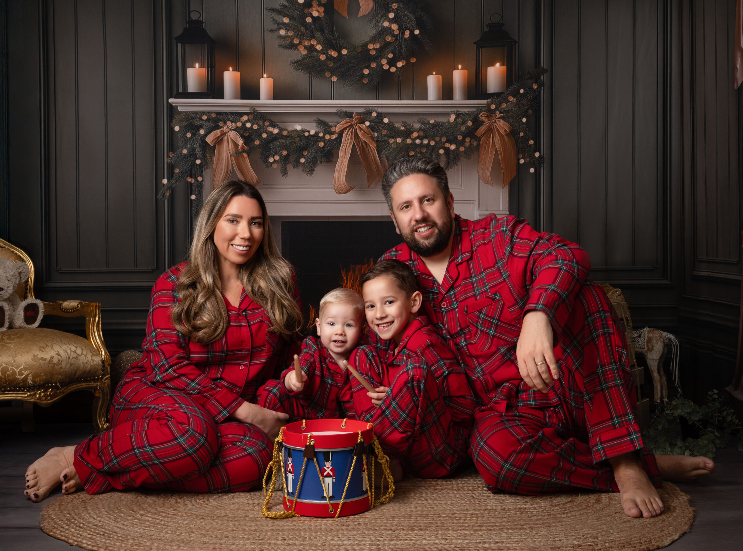 Family in tartan pyjamas in Christmas photo shoot